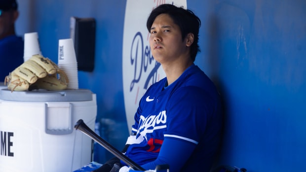 Shohei Ohtani watches a spring training game from the dugout.